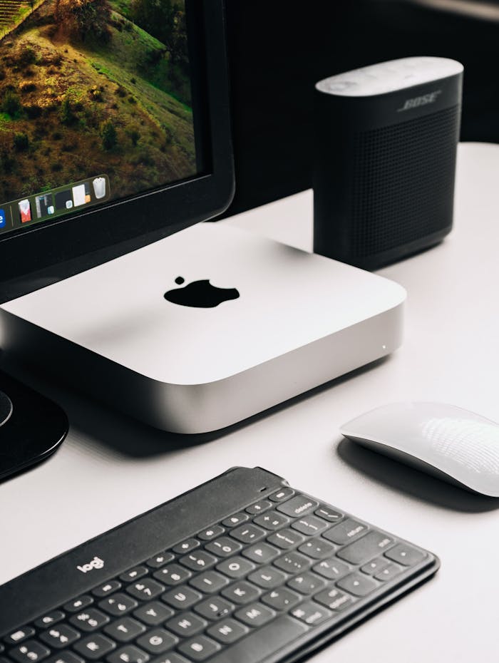 Sleek computer setup featuring a monitor, keyboard, and speaker for productivity.
